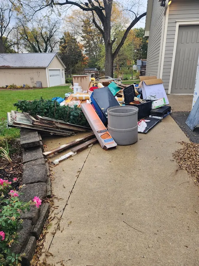 Dumpster being loaded with debris for 12 Yard Dumpster Rental in Corinth